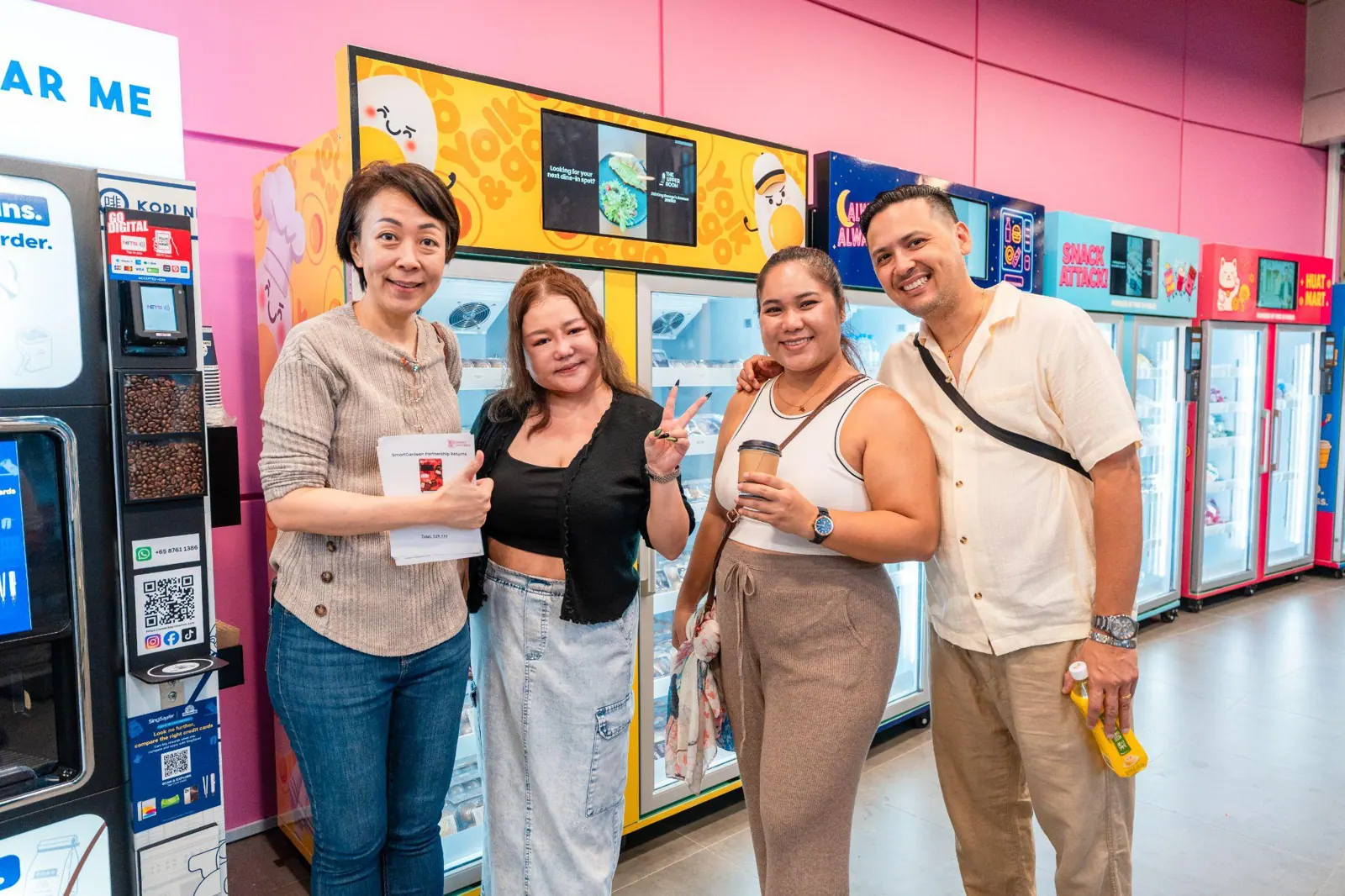 Partners in front of Pink in Public smart retail machines